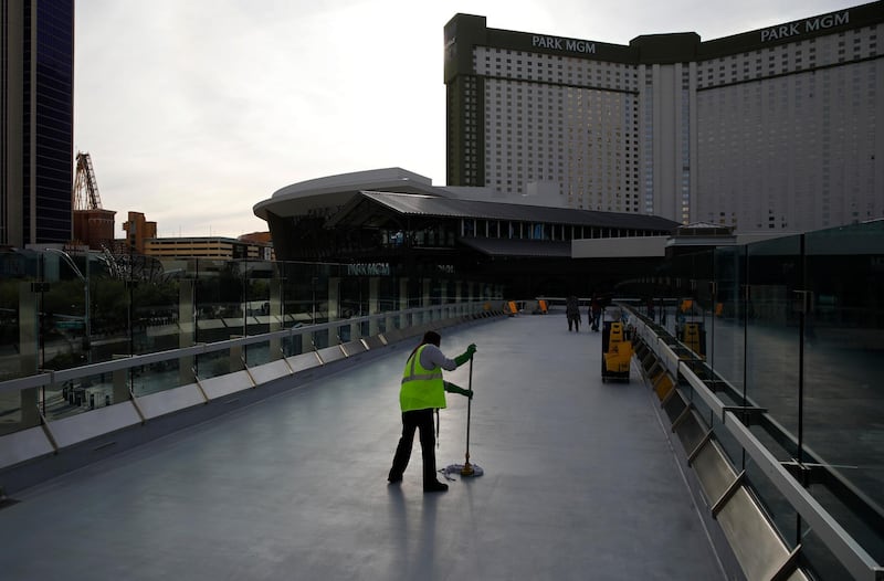 A worker cleans along the Las Vegas Strip devoid of the usual crowds as casinos and other business are shuttered due to the coronavirus outbreak. AP