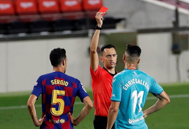 Referee Sanchez Martinez shows the red card to Osasuna's Enric Gallego. EPA