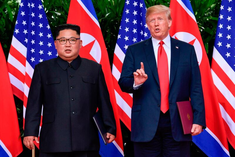 TOPSHOT - US President Donald Trump makes a statement before saying goodbye to North Korea leader Kim Jong Un (L) after their meetings at the Capella resort on Sentosa Island in Singapore on June 12, 2018.  Donald Trump and Kim Jong Un became on June 12, the first sitting US and North Korean leaders to meet, shake hands and negotiate to end a decades-old nuclear stand-off. / AFP / POOL / Susan Walsh

