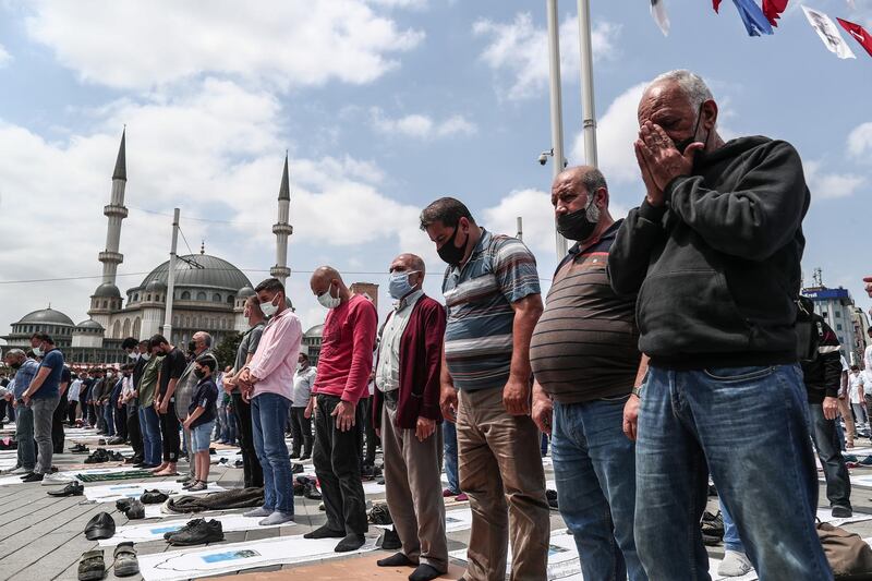 People pray at the Friday prayer in front of the newly built Taksim Mosque at Taksim Square, during the opening ceremony of the mosque in Istanbul, Turkey. EPA