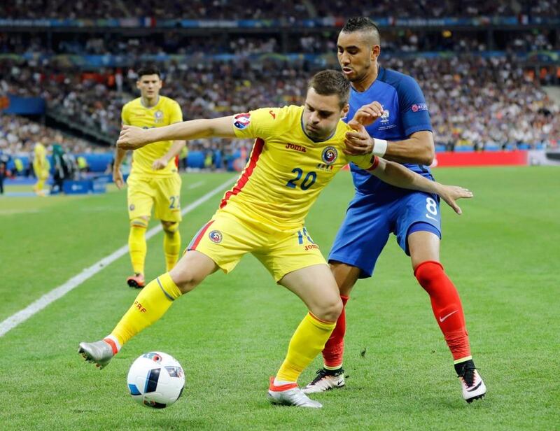 Romania's Adrian Popa, left, and France's Dimitri Payet vie for the ball during the Euro 2016 opener Friday. Romania were not daunted by the prospect of taking on the home team, and our columnist hopes other teams will be encouraged to play attacking football of a similar nature. Frank Augstein / AP Photo