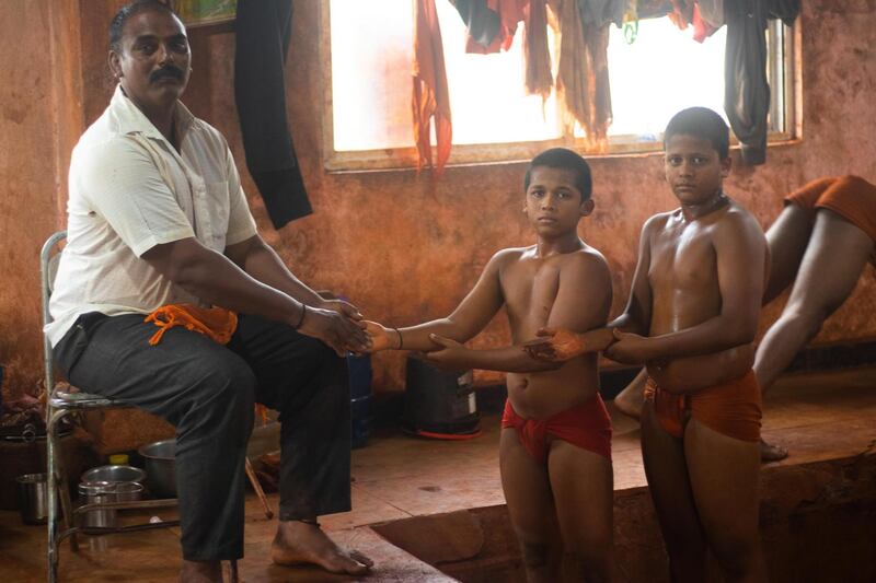 Before starting their training, every wrestler touches the feet of vastaad (coach) as a tradition. Sanket Jain for The National