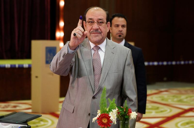 Iraqi Vice President and former Prime Minister Nuri al-Maliki shows his ink-stained finger after casting his vote at a polling station during the parliamentary election in Baghdad. Ahmed Jadallah / Reuters