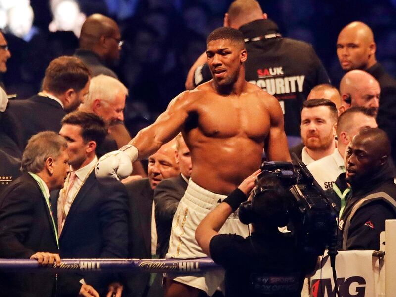 FILE- In this file photo dated Saturday, April 29, 2017, British boxer Anthony Joshua celebrates after beating Ukrainian Wladimir Klitschko at Wembley stadium in London.  Big punching contenders Anthony Joshua and Joseph Parker will put their titles and reputations on the line it is announced Sunday Jan. 14, 2018, when they meet for a world heavyweight title clash in Cardiff on upcoming March 31. (AP Photo/Matt Dunham, FILE)