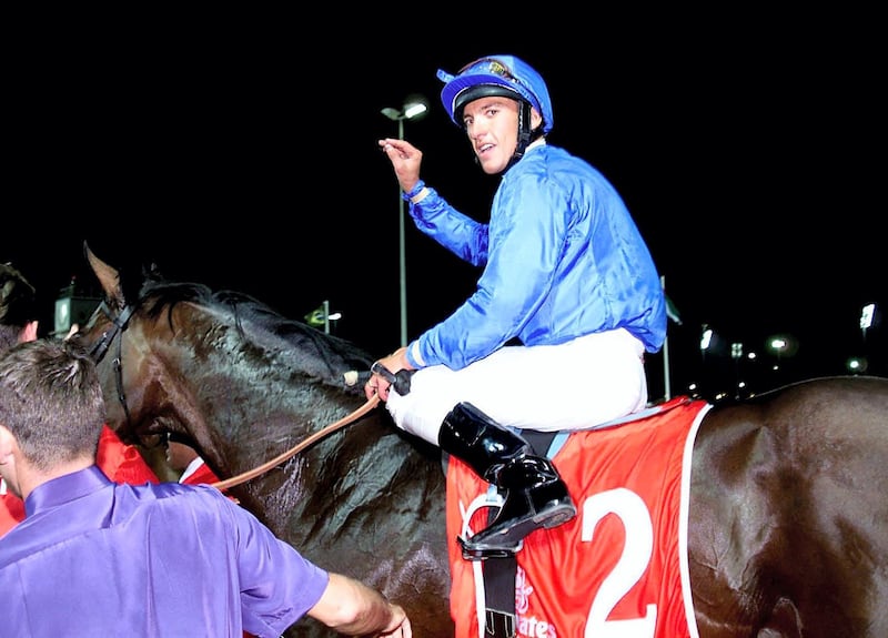 Jockey Frankie Dettori, winner of the world's richest horse race, gestures as he is driven on top of Dubai Millennium to the podium 25 March 2000. Dubai Millennium is owned Sheikh Mohamed Bin Rashed Al-Maktoum, UAE Minister of Defence and Crown Prince of Dubai. (ELECTRONIC IMAGE) (Photo by JORGE FERRARI / AFP)