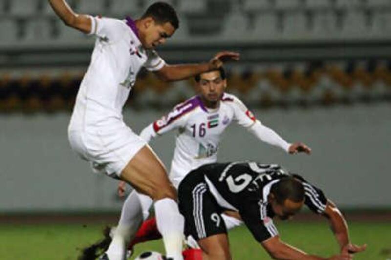 Al Jazira's Fernando Baiano, who scored the game's decisive second goal, is knocked down by Al Ain's Esmaiel Ahmed.