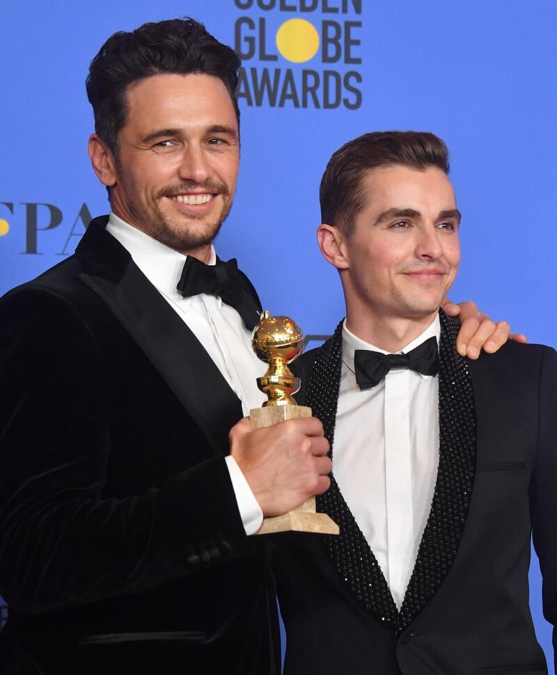 Dave Franco poses with James Franco and his trophy for Best Performance by an Actor in a Motion Picture - Musical or Comedy. AFP