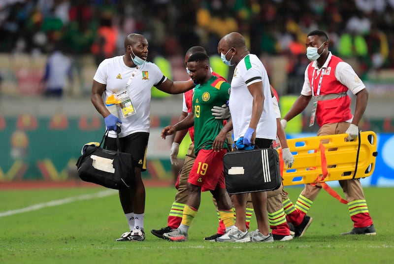 Cameroon's Collins Fai walks off the pitch after receiving medical attention. Reuters