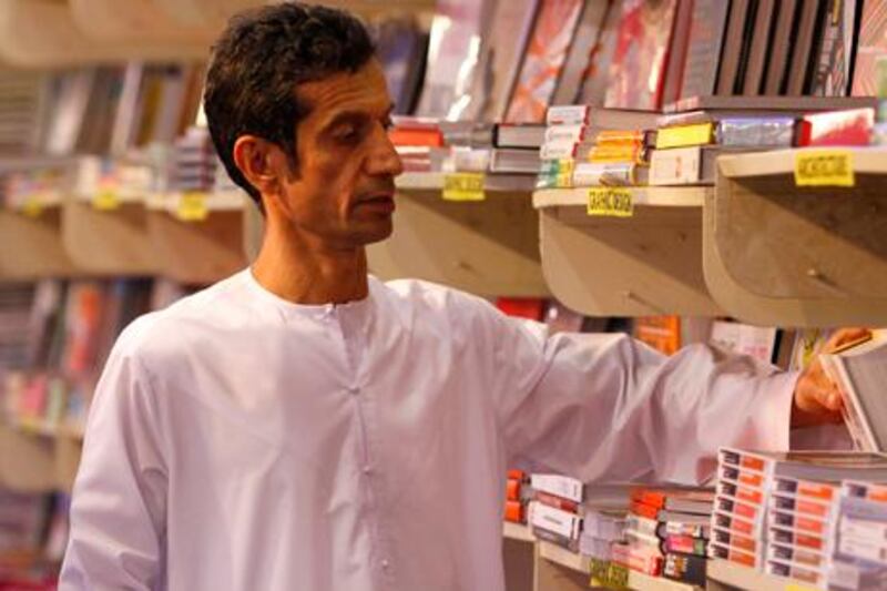 A man studies the offerings at this year’s Sharjah Book Fair. The availability of Arabic literature is growing, and the popularity of such writing is on the rise among readers.