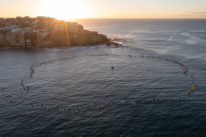 Australian surfers and lifeguards paddle out at Bondi Beach to honour the victims of the Westfield Bondi Junction stabbings in Sydney. EPA
