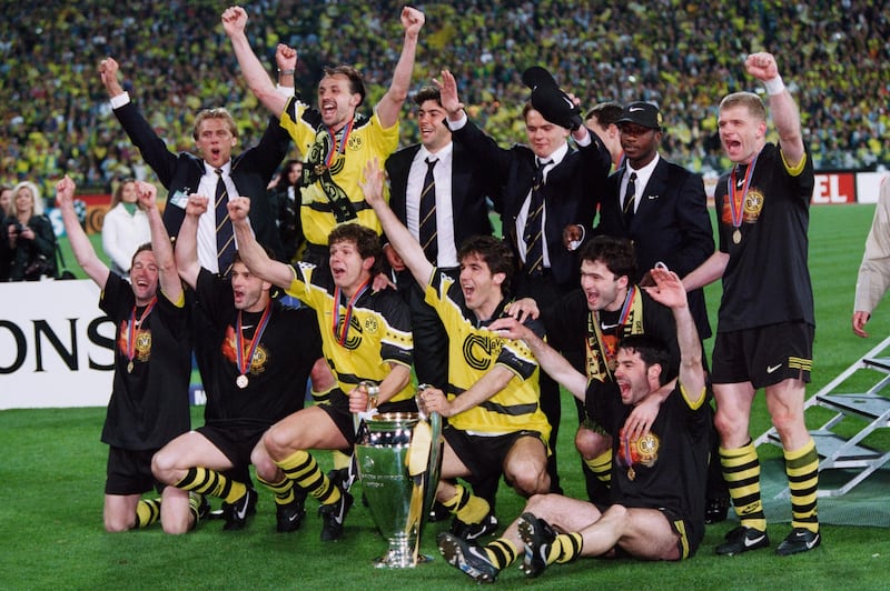 28 May 1997, Munich, Germany --- Borussia Dortmund's players celebrate with the trophy after they won the 1996-1997 UEFA Champions League final against Juventus 3-1. --- Image by © Christian Liewig/TempSport/Corbis