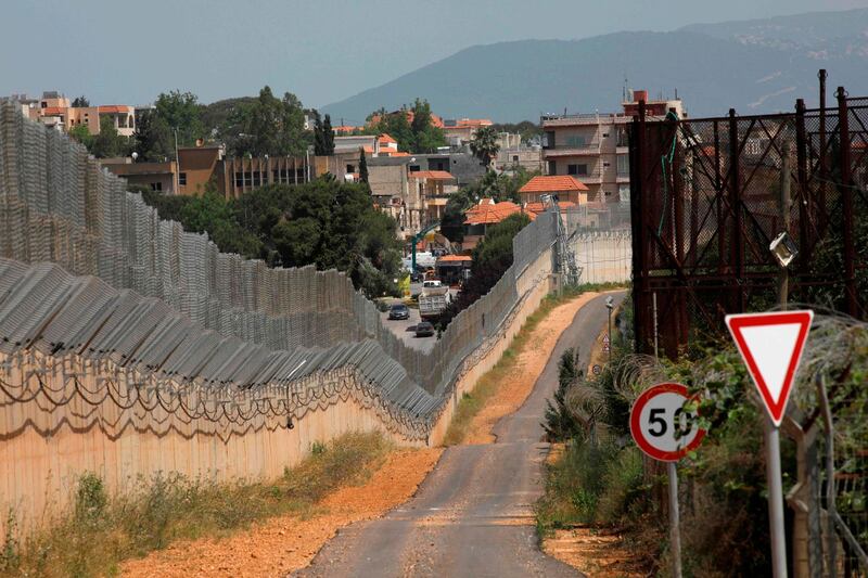 ISRAEL & LEBANON: A picture taken from the northern Israeli town of Metulla shows a stretch of the border fence and a view of the southern Lebanese village of Kfar Kila, on May 22, 2020, ahead of the 20th anniversary of Israel's withdrawal from southern Lebanon. AFP