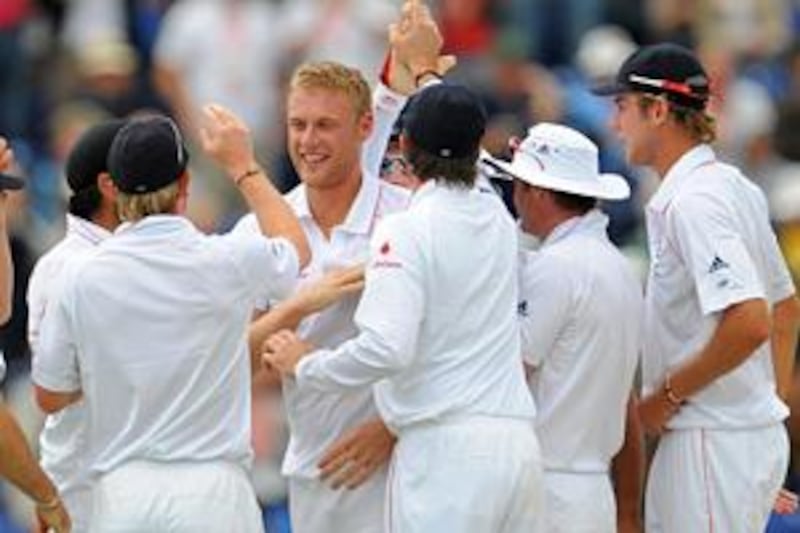The England bowler Andrew Flintoff is congratulated by his teammates after claiming the wicket of Australian opener Phillip Hughes.