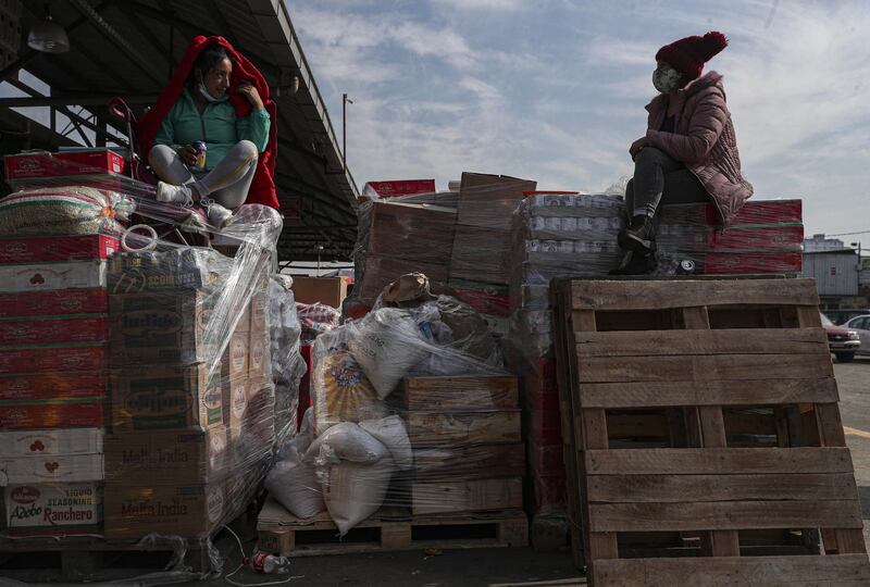 Merchants chat in La Vega market in Santiago, Chile. AP Photo