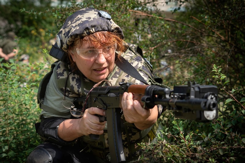 A Ukrainian woman practices with a rifle during volunteer military training for civilians near Kyiv. AP