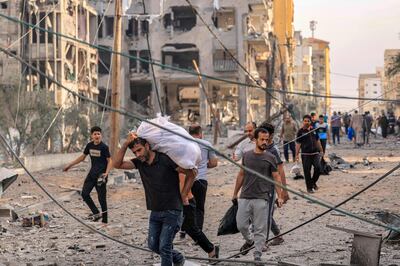 Palestinians leave Al Karama neighbourhood in Gaza City to safer areas after Israeli air strikes. AFP 