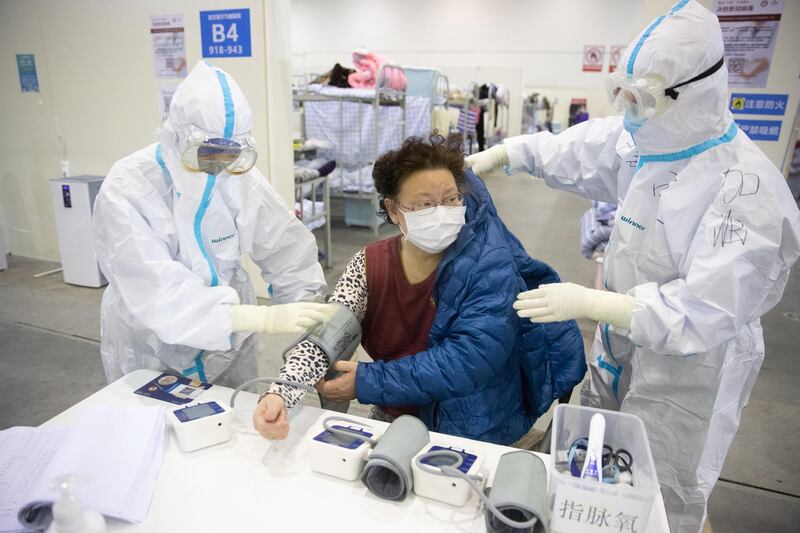Medical staff in protective suits attend to patients at Wuhan Fang Cang makeshift hospital in Wuhan, Hubei Province, China.  EPA
