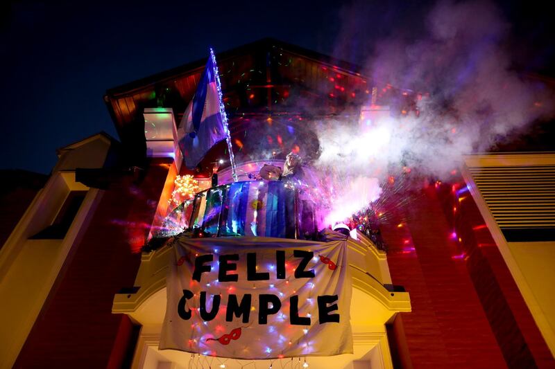 Marcela Alvarez holds her birthday party in her home's balcony in Buenos Aires. AP Photo