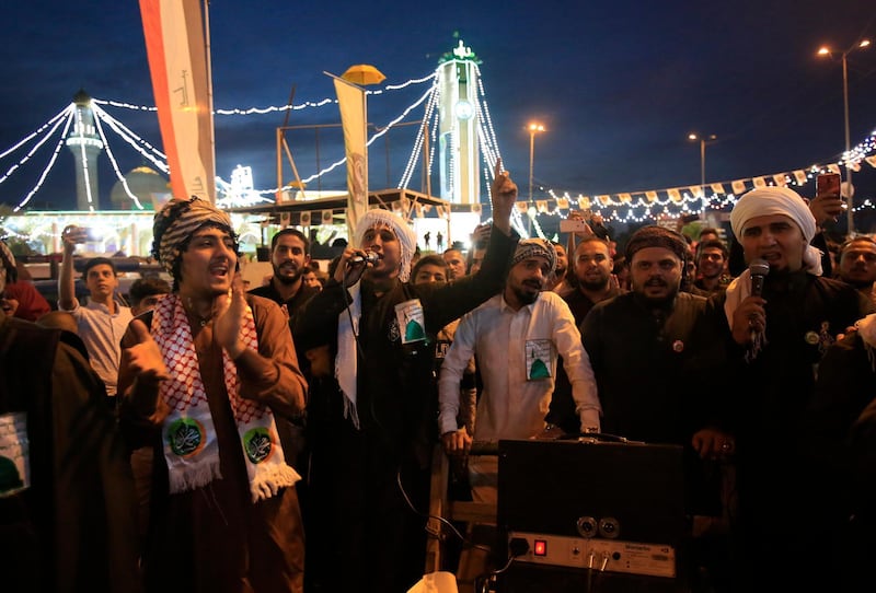 People gather to mark the birth anniversary of the Prophet Muhammad in the Azamiyah neighborhood in Baghdad, Iraq, Monday, Nov. 19, 2018.(AP Photo/Karim Kadim)