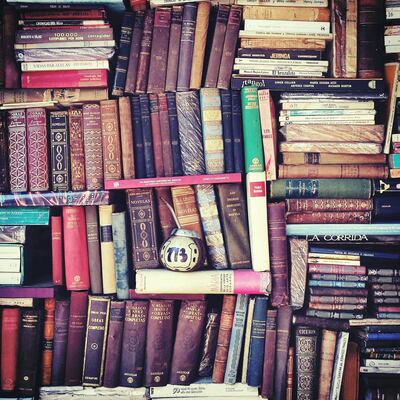 Old Books Stacked On Shelf. Getty Images