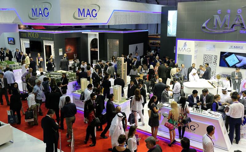 Visitors browse scaled versions of Group Mag's new projects at the Cityscape Global 2014. Satish Kumar / The National
