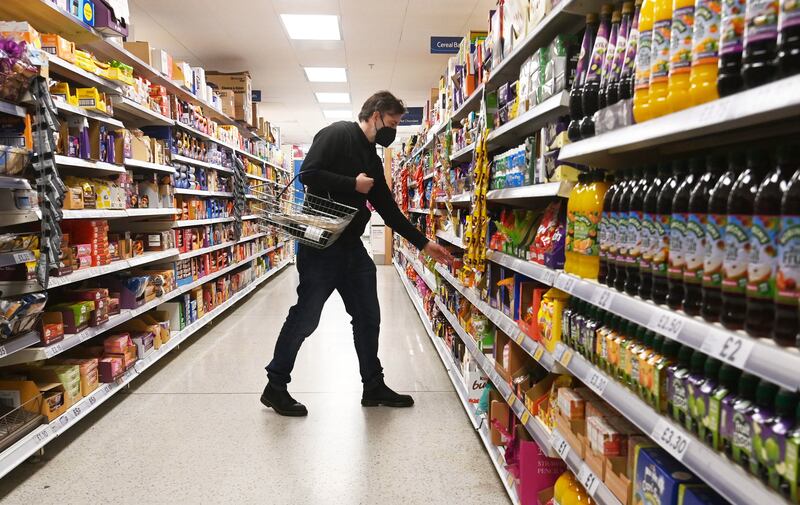 Crunch time: a man shops in a supermarket in London. EPA