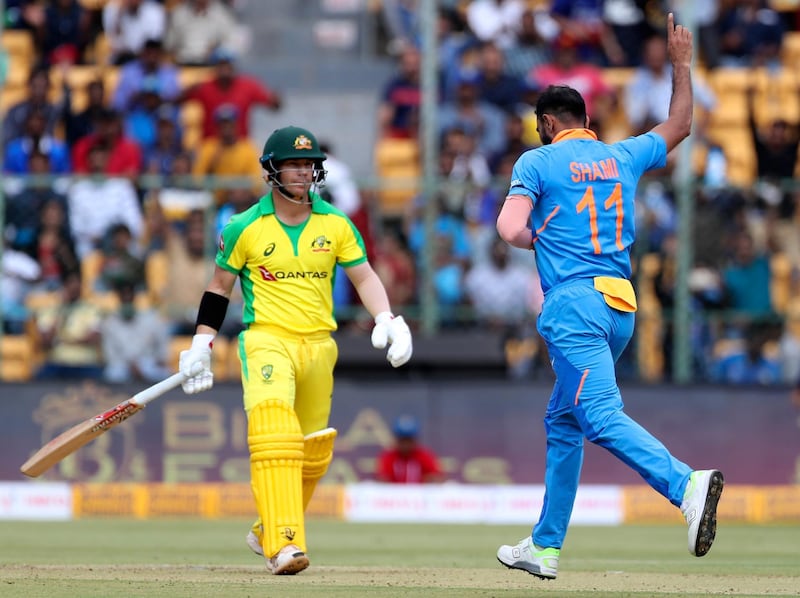 India bowler Mohammed Shami, right, celebrates the dismissal of Australia opener David Warner. AP