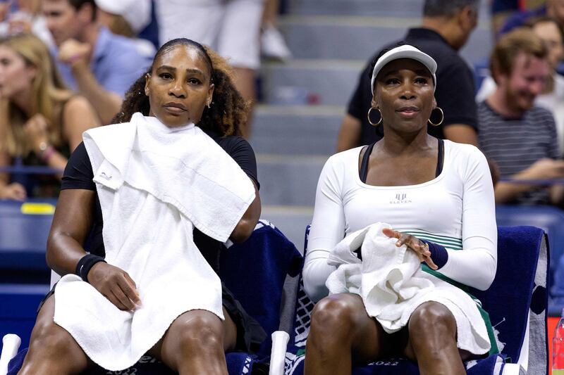 Serena Williams, left, and sister Venus sit on the bench between games against Lucie Hradecka and Linda Noskova during their 2022 US Open. AFP