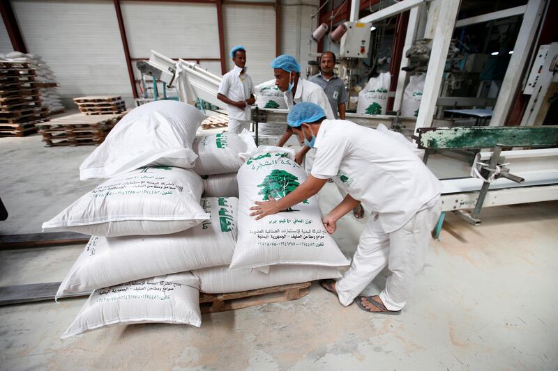 Workers prepare wheat sacks at the Red Sea port of Salif, Yemen September 30, 2017. Picture taken September 30, 2017. To match Special Report YEMEN-SAUDI/BLOCKADE REUTERS/Abduljabbar Zeyad