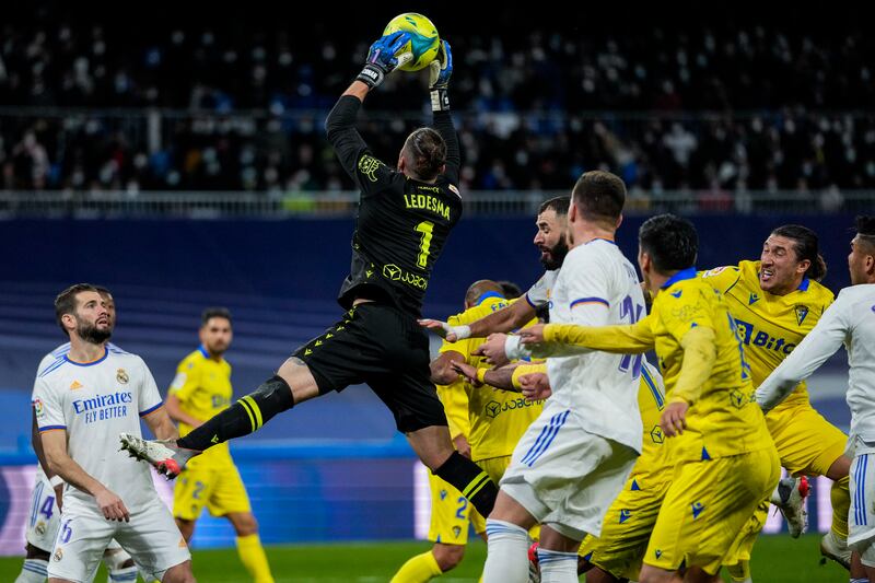 Cadiz goalkeeper Jeremias Ledesma leaps to catch a high ball. AFP
