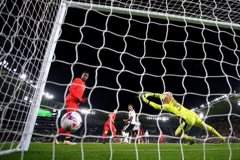 Ragnar Klavan of Liverpool scores the opening goal past Jonathan Mitchell of Derby County. Richard Heathcote / Getty Images