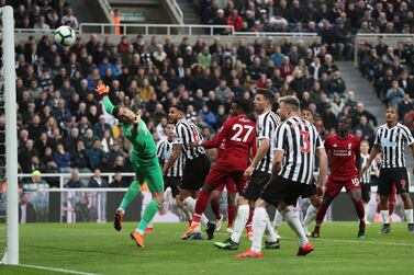 Divock Origi, red in the cente, heads home Liverpool's winner against Newcastle United. Reuters