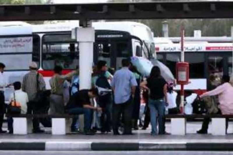 DUBAI-JULY 9,2008 - Commuters waiting at the bus station in Al Satwa,Dubai. ( Paulo Vecina/The National )  *** Local Caption ***  PV commuters 4.JPG