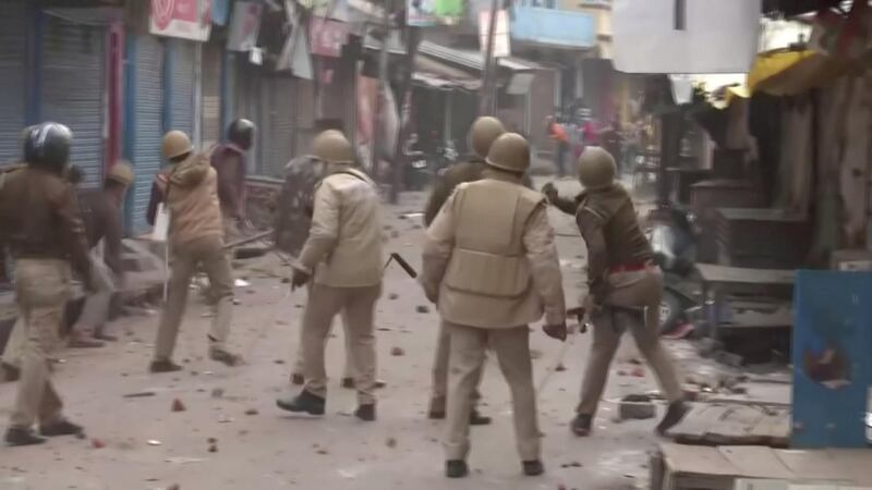 Police personnel pelt stones at protesters during clashes over citizenship law in Gorakhpur. Reuters