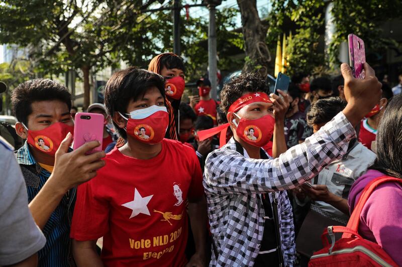 People use their smartphones to live stream a protest outside Myanmar's embassy in Bangkok, Thailand. Getty Images