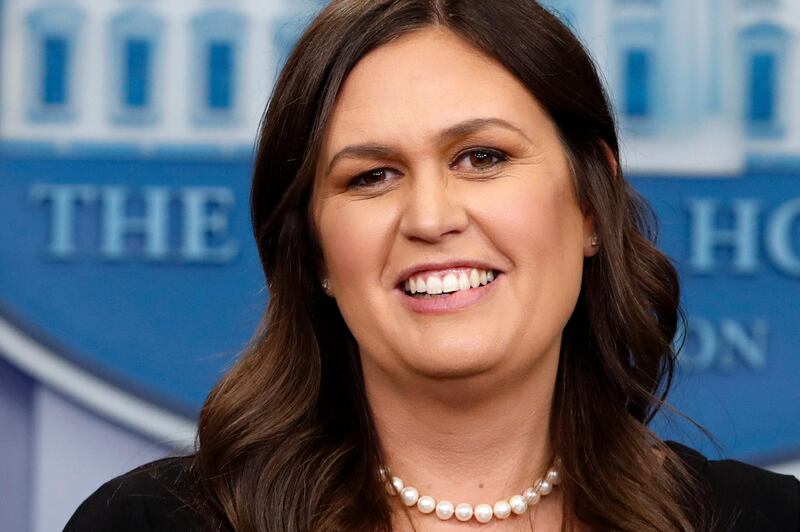 FILE - In this June 14, 2018 file photo, White House Press Secretary Sarah Huckabee Sanders smiles as she wishes President Donald Trump a happy birthday, during the daily briefing,  in the Briefing Room of the White House in Washington. Sanders acknowledges in a tweet that she was asked to leave a Virginia restaurant Friday night, June 22. Sanders said she was told by the owner of The Red Hen in Lexington, Virginia, that she had to "leave because I work for @POTUS and I politely left."  Sanders' treatment at the restaurant has created a social media commotion with people on both sides weighing in to provide their critique of the incident. (AP Photo/Jacquelyn Martin, File)