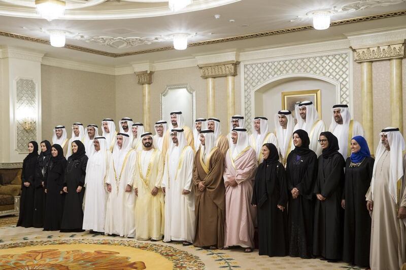 Sheikh Mohammed bin Rashid, Prime Minister and Ruler of Dubai, and Sheikh Mohammed bin Zayed, Crown Prince of Abu Dhabi and Deputy Supreme Commander of the Armed Forces, stand for a photograph with ministers during their swearing-in ceremony at Mushrif Palace on Sunday. Ryan Carter / Crown Prince Court – Abu Dhabi