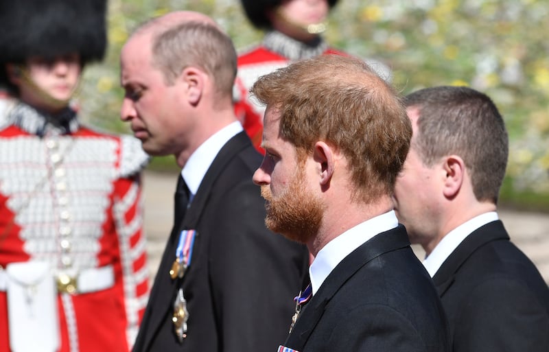 Prince William and Prince Harry follow the coffin during a procession arriving at St George's Chapel for the funeral of Britain's Prince Philip inside Windsor Castle in Windsor, England, Saturday, April 17, 2021. Prince Philip died April 9 at the age of 99 after 73 years of marriage to Britain's Queen Elizabeth II. (Mark Large/Pool via AP)