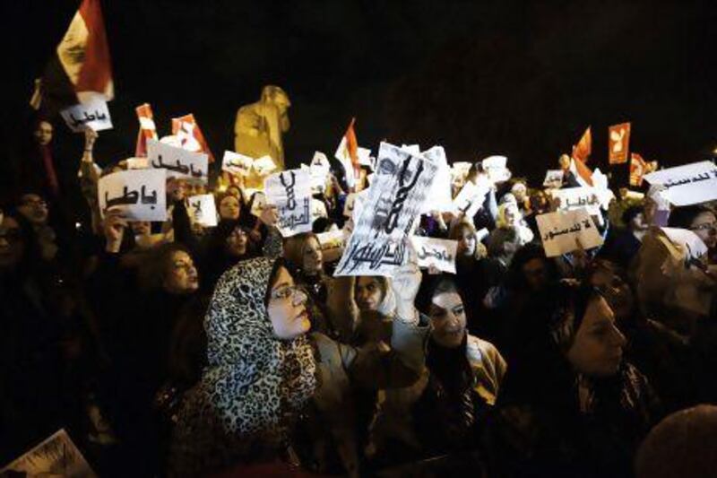 Egyptian women, some holding up signs that read in Arabic, ‘Void’ and ‘No to the Constitution’, demonstrate in front of the Cairo Zoo in Giza.