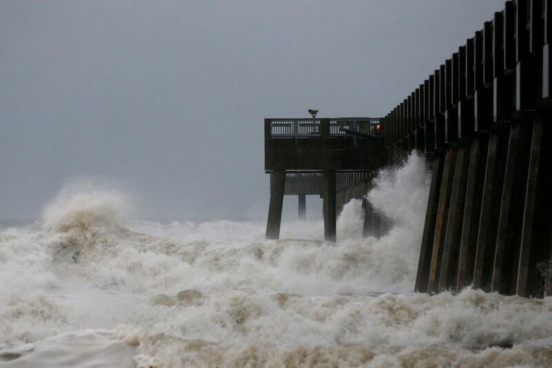 Waves crash along a pier as Hurricane Michael approaches Panama City Beach, Florida, U.S. October 10, 2018. REUTERS/Jonathan Bachman