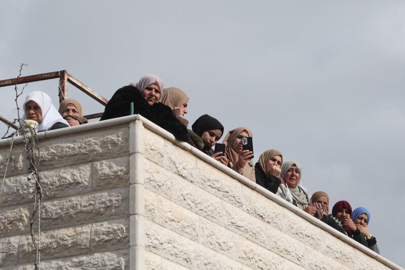 Mourners watch the funeral procession of two Palestinians who died following an Israeli raid in Dura, south of Hebron, on Monday. The Palestinian Authority's failure to counter Israeli settlements or security crackdowns has left many West Bank residents disillusioned. AFP