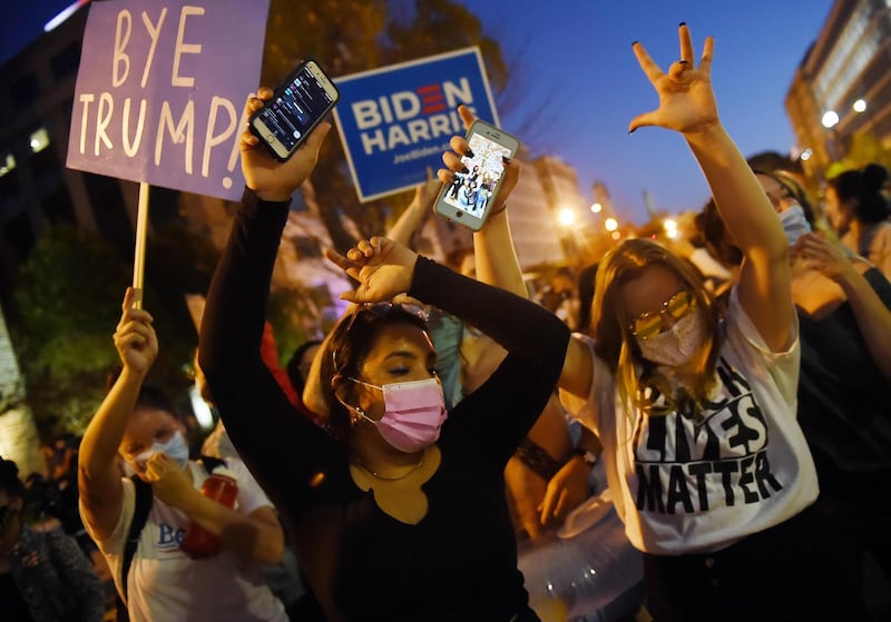 Supporters of US President-elect Joe Biden celebrate on Black Lives Matter Plaza across from the White House in Washington, DC.  AFP