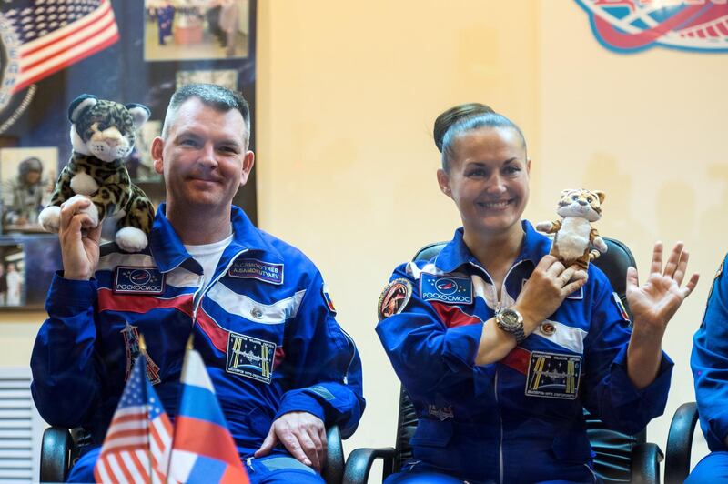 Expedition 41 Soyuz Commander Alexander Samokutyaev of the Russian Federal Space Agency (Roscosmos) and Flight Engineer Elena Serova of Roscosmos hold up tiger toys that will be carried with them to the International Space Station to commemorate International Tiger Day at a press conference held at the Cosmonaut Hotel in Baikonur, Kazakhstan on Wednesday, Sept. 24, 2014. The mission is set to launch Sept. 26 from the Baikonur Cosmodrome. Photo Credit: (NASA/Aubrey Gemignani)