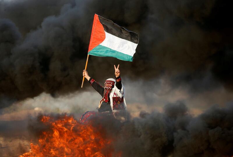 A woman on the Gaza Strip waves a Palestinian flag during a protest against the Israeli blockade. Reuters