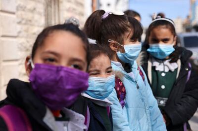 Palestinian girls wearing masks amid the Covid-19 pandemic leave their school in Gaza City. AFP