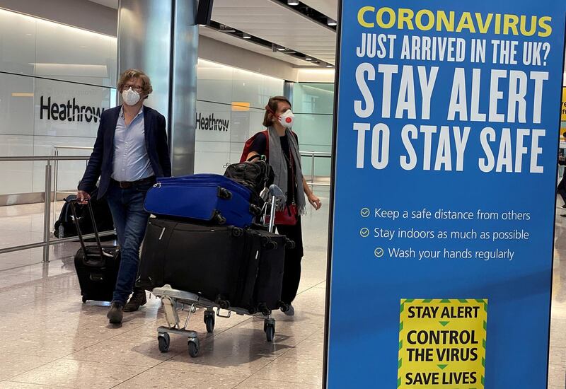 FILE PHOTO: Passengers arrive at Heathrow Airport, as Britain launches its 14-day quarantine for international arrivals, following the outbreak of the coronavirus disease (COVID-19), London, Britain, June 8, 2020. REUTERS/Toby Melville/File Photo
