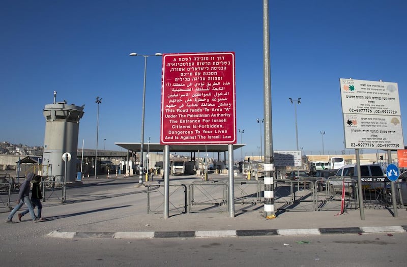 An Israeli sign, written in Hebrew, Arabic and English, at the entrance of the Qalandiya checkpoint between Jerusalem and Ramallah. Ahmad Gharabli / AFP / February 9, 2014