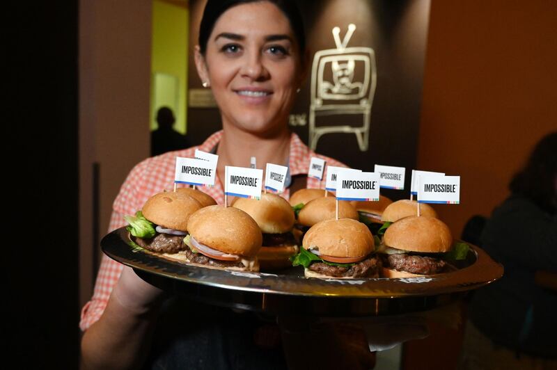 The Impossible Burger 2.0, the new and improved version of the company's plant-based vegan burger that tastes like real beef is introduced at a press event. AFP