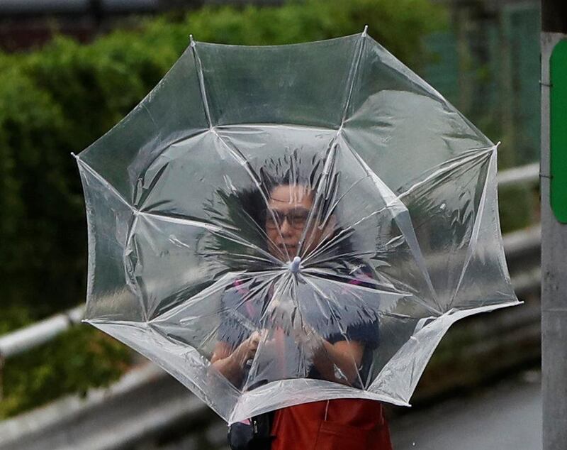 A woman using an umbrella struggles against a heavy rain and wind caused by Typhoon Faxai in Tokyo, Japan September 9, 2019. REUTERS/Issei Kato