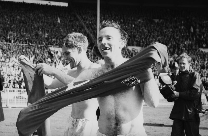Teammates Alan Ball, left, and Nobby Stiles celebrate after England's victory in the 1966 World Cup final at Wembley in 1966. Getty